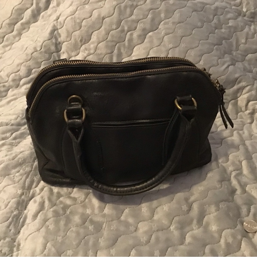 Black pleather, 3 compartments, 2 zip 1 snap in center.